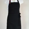 black apron with red